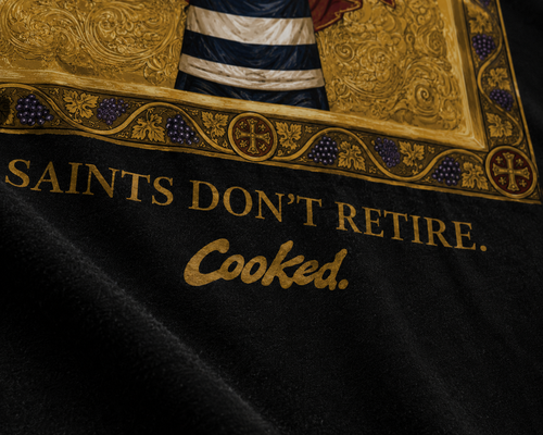 LIVES FOREVER — Cooked 001 on black tee, worn back view, kitchen setting.